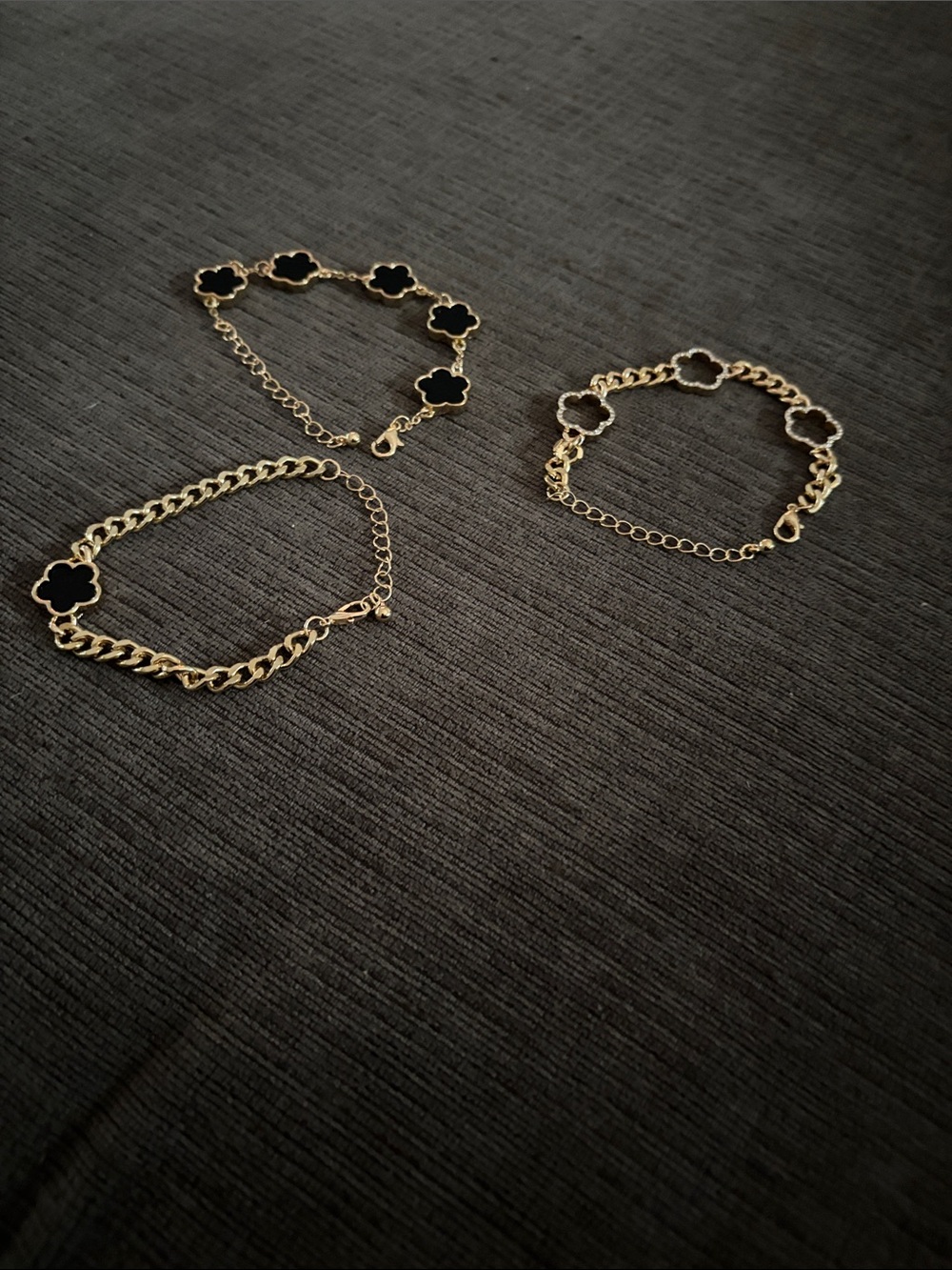 2 Gold Bracelet with Black Clover Motifs, 1 bracelet with cut out clover motif